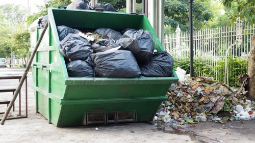 Inspector reviewing commercial waste containers during site visit